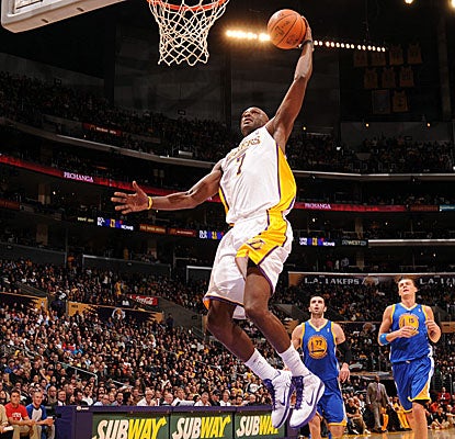 Lamar Odom lifts off for the dunk Sunday against the Warriors. (Getty Images)