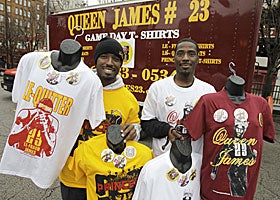 Enterprising Cavs fans sell 'Queen James 23' shirts in Cleveland in advance of James' return. (AP)