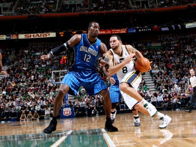 Deron Williams drives past Dwight Howard on his way to score a season-high 32 points.  (Getty Images)
