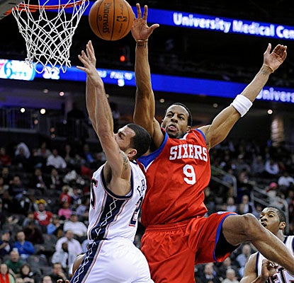 Andre Iguodala swats away a Jordan Farmar bunny on Tuesday as the Sixers take a road win out of Newark. (Getty Images)
