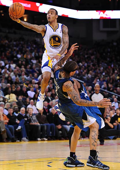 Monta Ellis, who winds up with a game-high 34 points, skies over Michael Beasley in the third quarter.  (US Presswire)