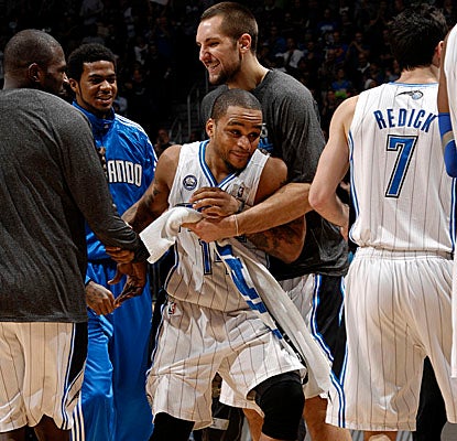 Jameer Nelson is congratulated by Magic teammates Saturday after scoring 10 of his 12 points in the 4th for Orlando's win. (Getty Images)