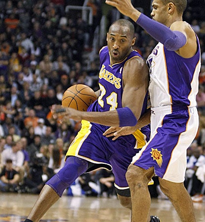 Kobe Bryant tries to drive on a Suns defender for two of his game-high 24 points. (AP)