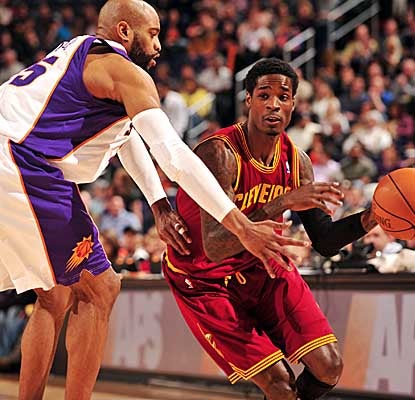 Rookie Manny Harris drives past the Suns' Vince Carter, scoring a season-high 27 points in the Cavs' loss. (Getty Images)
