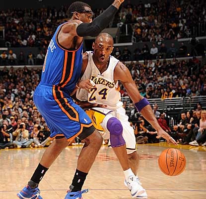 Driving past Knicks star Amar'e Stoudemire, Kobe Bryant leads the Lakers' attack with 27 points. (Getty Images)