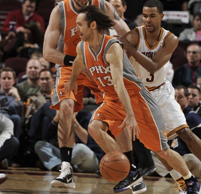 Steve Nash drives past Ramon Sessions of the Cavaliers on his way to 15 points and 15 assists.  (Getty Images)