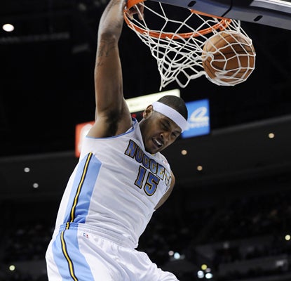 Carmelo Anthony dunks for two of his 35 points against the Thunder as the Nuggets win. (AP)