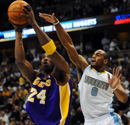 Nuggets guard Arron Afflalo tries to slow down Kobe Bryant, who goes on to lead the Lakers with 18 points. (AP)