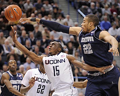 Connecticut's Kemba Walker drives past Georgetown's Julian Vaughn in the second half.  (AP)