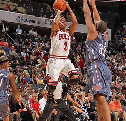 With Michael Jordan sitting courtside, Derrick Rose pulls down four boards, dishes out six assists and nets 20 points. (Getty Images)