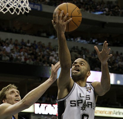 Tony Parker gets past Dirk Nowitzki and goes on to lead the Spurs with 33 points as San Antonio hol (AP)