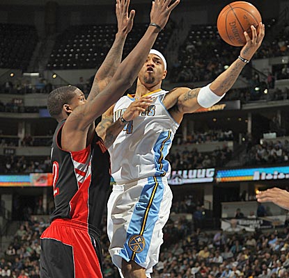 Kenyon Martin lays up a shot against Ed Davis, and the Nuggets leave the Raptors grasping for air in a 33-point blowout. (Getty Images)