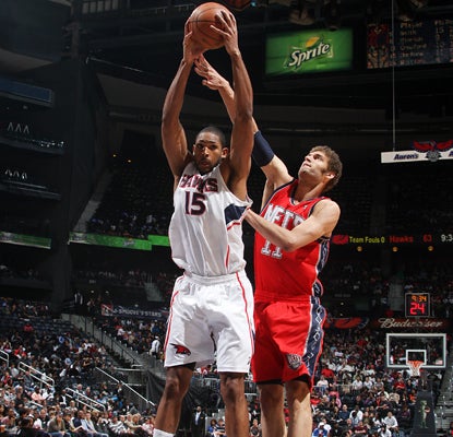 Al Horford grabs one of his 12 rebounds and also adds 23 points as he leads the Hawks to a win over the Nets. (Getty Images)