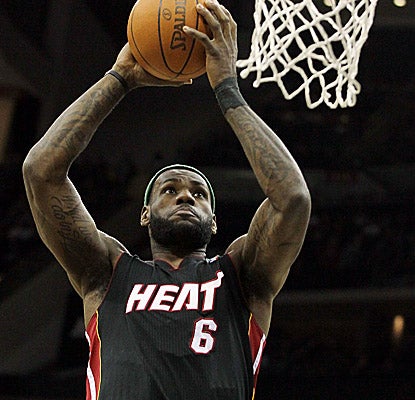 LeBron James slams one home, helping the Heat win with 31 points, 11 boards and seven dimes. (Getty Images)