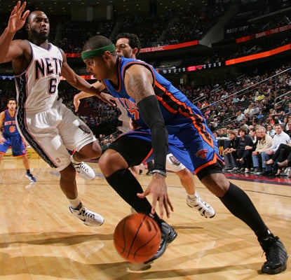 Carmelo Anthony goes to work as he leads the Knicks to a win over the Nets by contributing 25 points and 14 rebounds. (Getty Images)