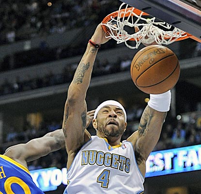 Kenyon Martin dunks in the second half of a rout where nine Nuggets players finish with double figures. (AP)