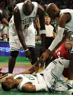 Writhing in pain, Kevin Garnett keeps telling Rajon Rondo to 'breathe.' (Getty Images)