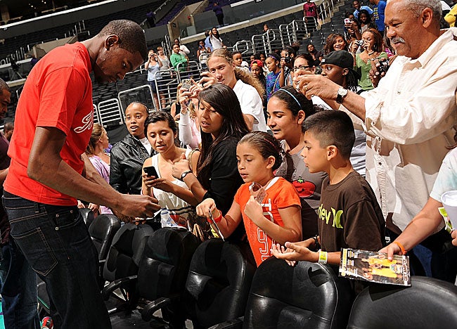 Here signing autographs at a WNBA game, Kevin Durant will star in Washington this weekend. (Getty Images)