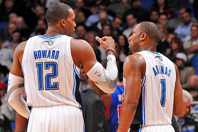 Dwight Howard earns by putting butts in seats; Gilbert Arenas is more likely to drive 'em away. (Getty Images)