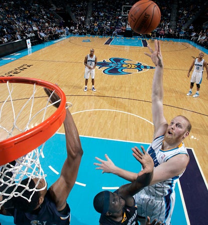 Chris Kaman goes up strong for two of his 18 points in his first appearance for the Hornets. (Getty Images)