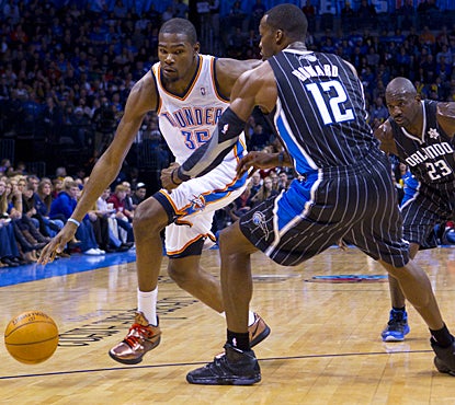 Dwight Howard and the Magic are no match for Kevin Durant (left), scoring 30 points in the win. (US Presswire)