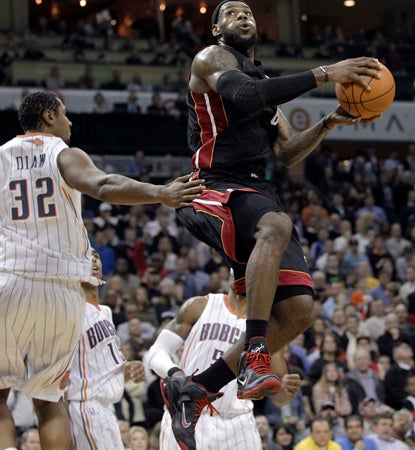 While Dwyane Wade suffers through injury, LeBron James carries the Heat with 35 points, seven dimes, and six boards. (AP)