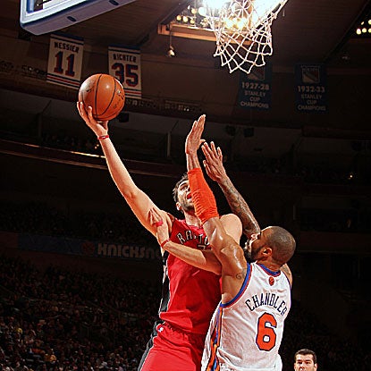 The Raptors' Andrea Bargnani goes over the Knicks' Tyson Chandler for two of his 21 points. (Getty Images)