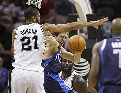 Tim Duncan helps make things tough on Dirk Nowitzki, who suffers one of the worst games of his career.  (Getty Images)