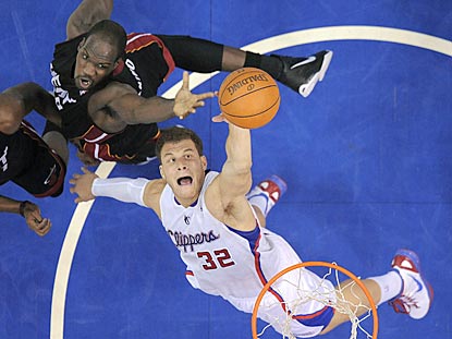 Blake Griffin beats Joel Anthony to a rebound in the first half. Griffin winds up 20 points with 12 boards.  (AP)