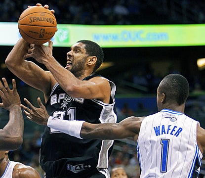 Tim Duncan gets fouled here, but still powers through the Magic for 17 points and 10 rebounds. (AP)