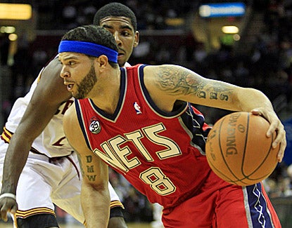 New Jersey's Deron Williams (right) drives past Cleveland's Kyrie Irving while scoring 27 points in the Nets' win. (AP)