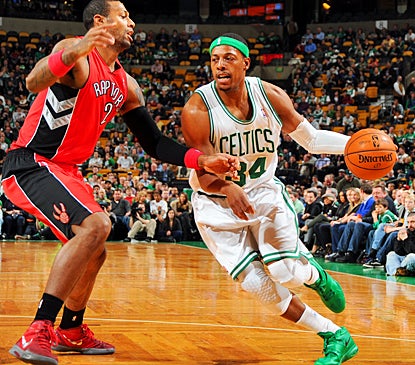 Boston's Paul Pierce drives around Toronto's James Johnson during the second quarter. (Getty Images)