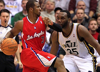 The Clippers' Chris Paul slips by the Jazz's Al Jefferson during the third quarter. (AP)