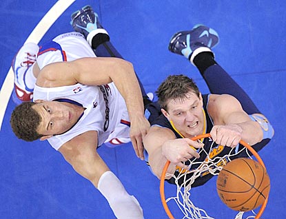 Now a Denver Nugget, Timofey Mozgov (right) gets the better of Blake Griffin in this matchup.  (AP)
