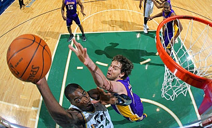 The Jazz's Paul Milsap battles for a basket against the Lakers' Pau Gasol during the first quarter. (Getty Images)