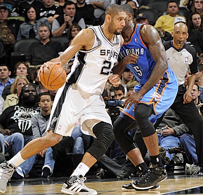 Tim Duncan grabs 15 boards, and fittingly, is the recipient of Tony Parker's record-breaking assist.  (Getty Images)