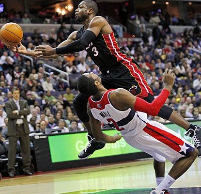 Dwyane Wade, who finishes with 26 points, scores or gets an assist on 20 consecutive points during one stretch. (US Presswire)