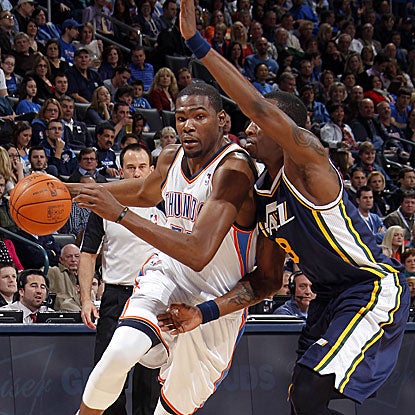 The Thunder's Kevin Durant blows by the Jazz's Josh Howard for two of his 21 points.  (Getty Images)