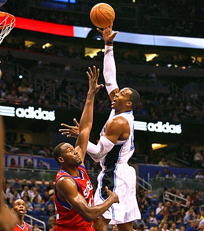 Dwight Howard helps the Magic's cause, scoring 17 points with 14 rebounds against the 76ers. (US Presswire)