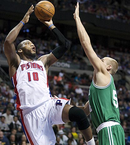 Detroit's Greg Monroe (10) shoots against Boston's Greg Stiemsma in the second half. Monroe winds up with a near triple-double. (AP)