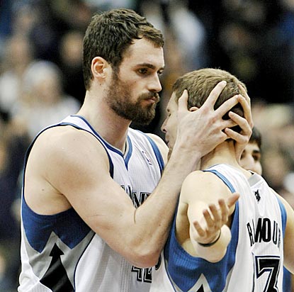 Kevin Love (left) gets a hug from Luke Ridnour after making the winning free throw with one-tenth of a second remaining.  (AP)