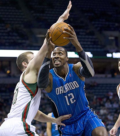 Dwight Howard powers past Jon Leuer in the first quarter en route to his 26th double-double of the season.  (US Presswire)