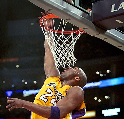 The Lakers' Kobe Bryant completes a layup during the first half against the Trail Blazers. (AP)