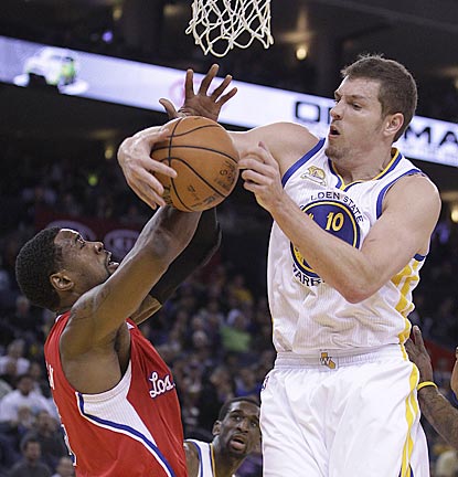With Blake Griffin in the house, David Lee (right) is the one who registers a double-double (24 points, 13 rebounds).  (AP)