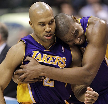 Derek Fisher (15 points) and Andrew Bynum (24 points) embrace a hard-fought win over the defending champion Mavericks.  (AP)