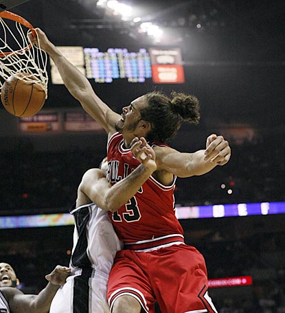 Despite Tim Duncan's defense, Bulls center Joakim Noah slams the ball home during the second half.  (US Presswire)