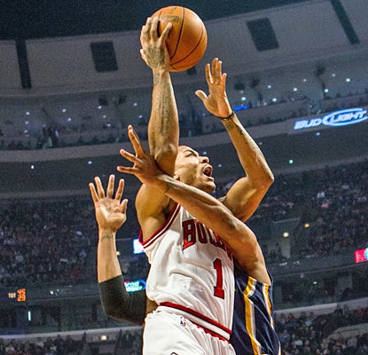 The Pacers hold Derrick Rose to just 13 points, but the Bulls' star still hurts them with nine assists and three 3-pointers. (AP)