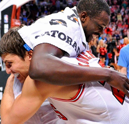 Kyle Korver celebrates with Luol Deng after Deng's putback sends the Bulls to their 40th win.  (US Presswire)