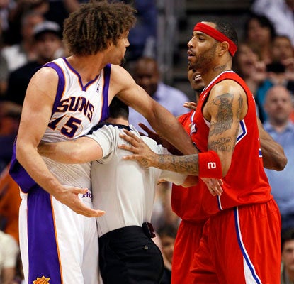 Robin Lopez and Kenyon Martin tangle in an intense game that features 24 lead changes.  (AP)