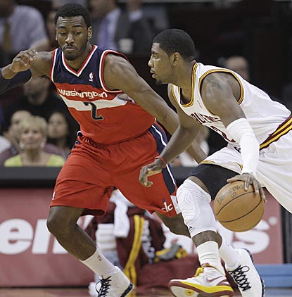 In a matchup between the past two No. 1 overall draft picks, John Wall (2) dazzles while Kyrie Irving plays only 10 minutes.  (AP)